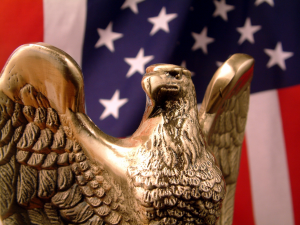 Golden Eagle in front of flag